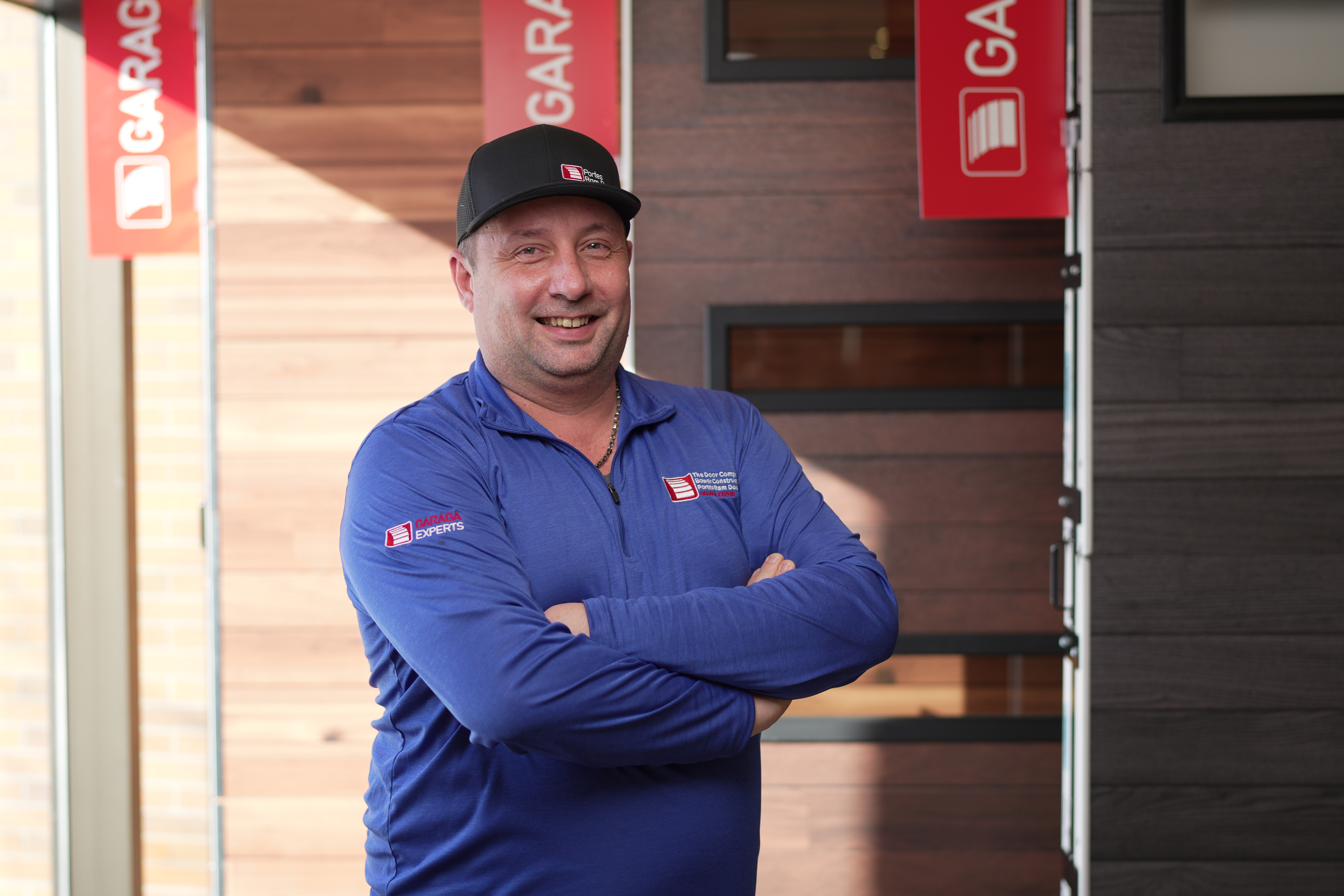 Garage door technician with a blue cap and tshirt