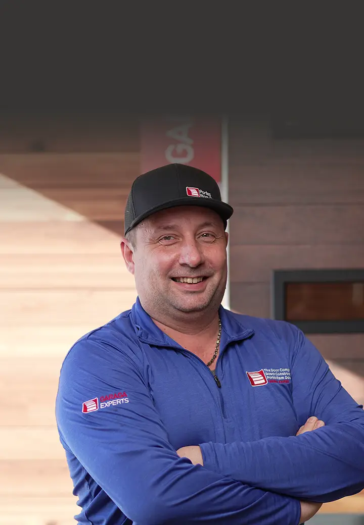 Luc Wheatley from The Door Company Ottawa standing in front of a garage door