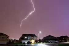 Houses with garage doors. Thunder and strike storm