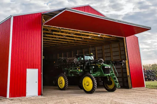 Bifold commercial door, perfect for this farm building in Metcalfe, Eastern Ontario, that did not have enough overhead space for a sectional door
